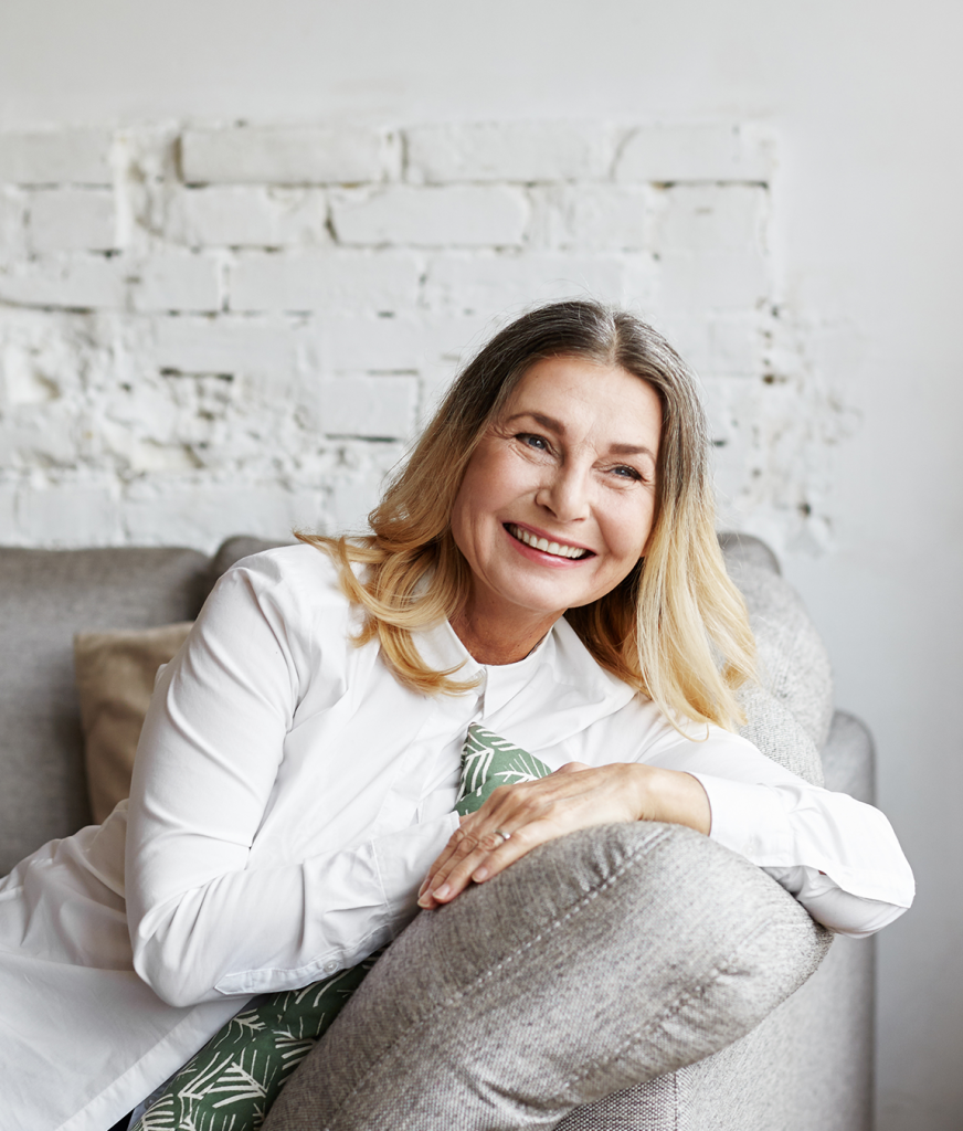 Woman leaning on a sofa arm