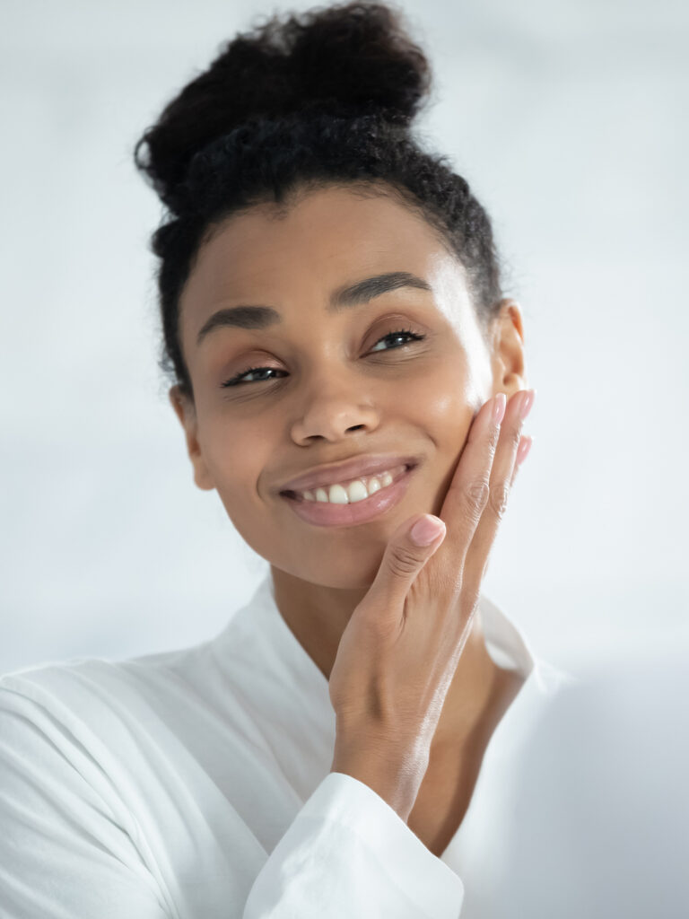 Woman with her hand against her cheek